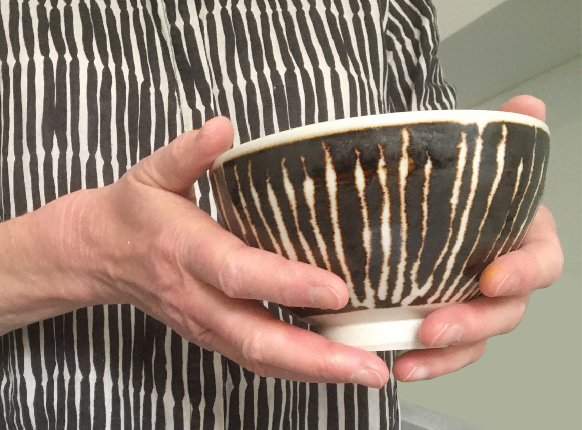 Hands holding ceramic bowl by Gary McPhedran